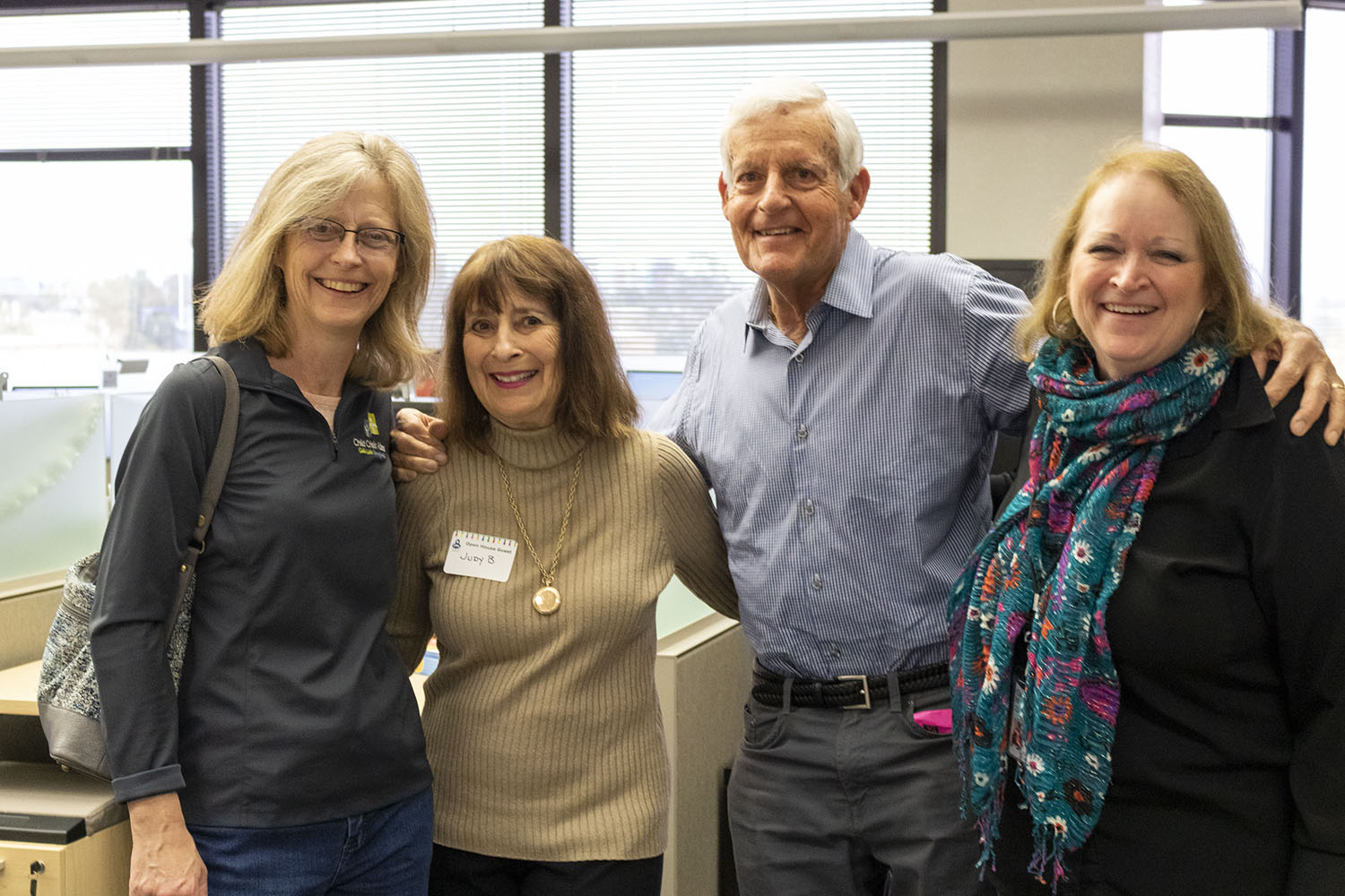 Four volunteers pose at the Volunteer Open House 2019